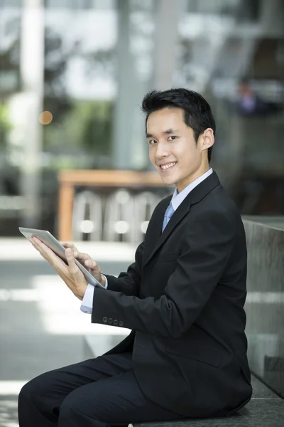 Chinese man with a tablet computer.