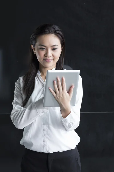 Chinese woman with a tablet computer.
