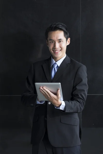 Chinese man with a tablet computer.