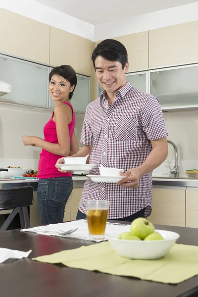 Happy Asian couple eating at home