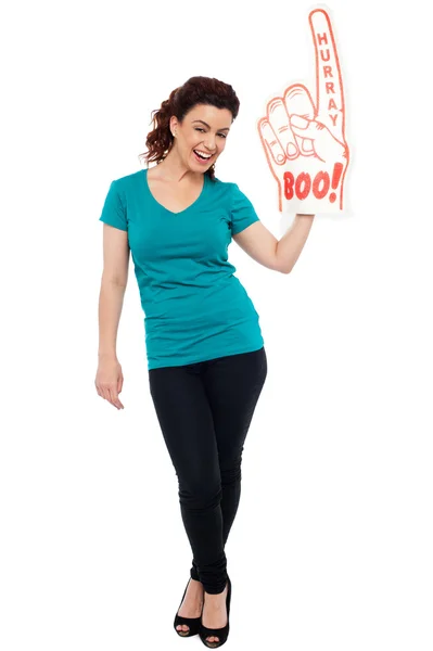 Woman cheering with large boo hurray foam hand — Stock Photo, Image