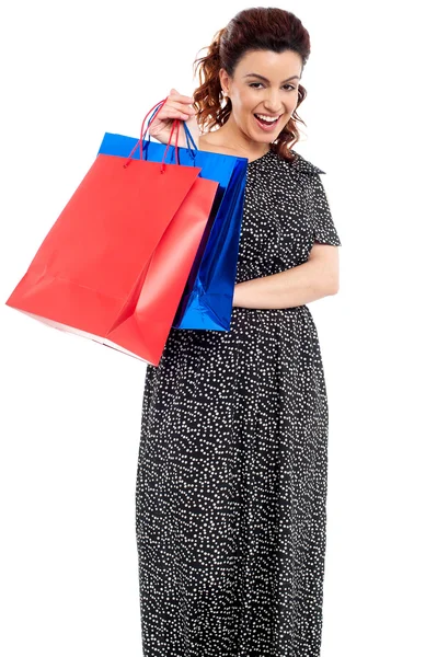 Profile shot of woman holding shopping bags — Stock Photo, Image