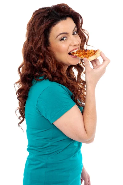 Pose lateral casual menina bonita desfrutando de pizza — Fotografia de Stock