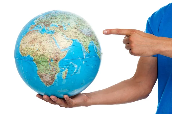 A finger pointing at the globe. closeup shot — Stock Photo, Image