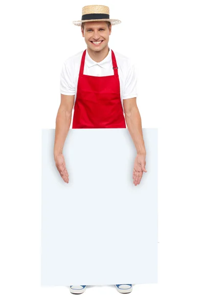 Male chef presenting you blank advertising board — Stock Photo, Image