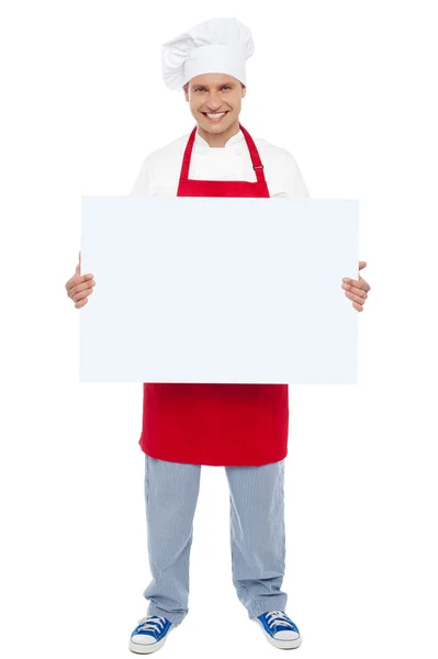 Chef holding blank white billboard. Full length shot — Stock Photo, Image