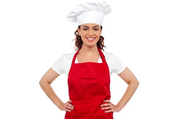 Cure female chef posing with hands on her waist Royalty Free Stock Photos