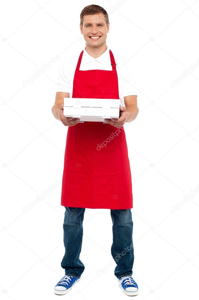 Full length portrait of male chef holding pie box