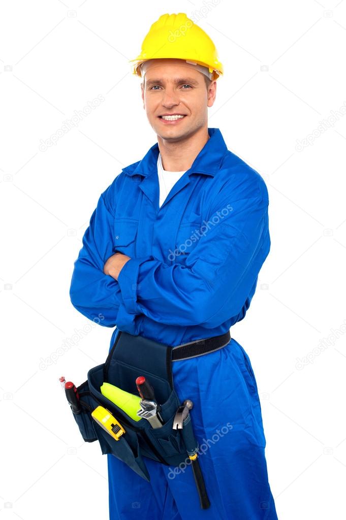 Young contractor with tool set and arms crossed