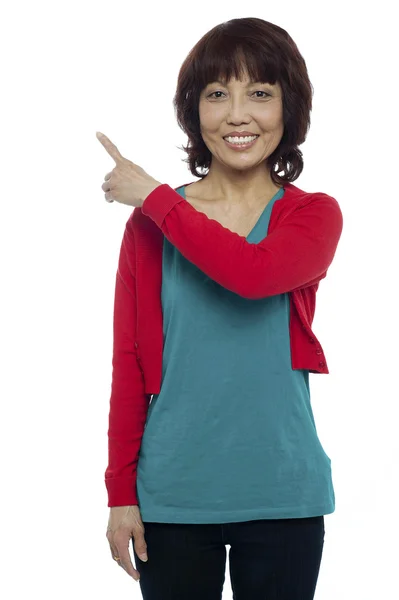 Asian model pointing at the copy space area — Stock Photo, Image