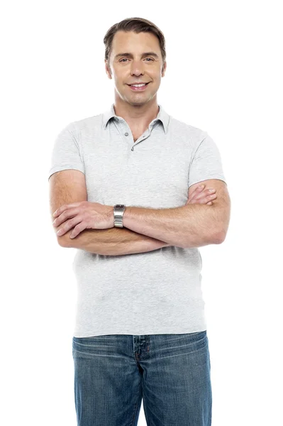 Joyous young man posing with his arms crossed — Stock Photo, Image