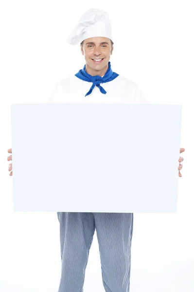 Handsome male chef holding ad board — Stock Photo, Image