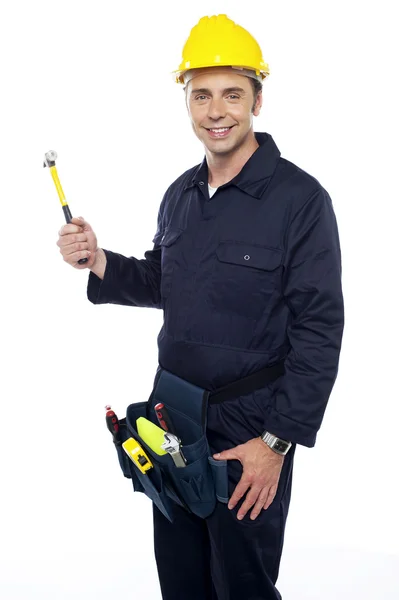 Repairman holding out hammer from his tool kit — Stock Photo, Image