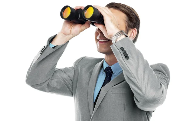 Businessman viewing through binoculars — Stock Photo, Image