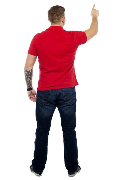 Postura traseira do homem apontando para área de espaço de cópia — Fotografia de Stock