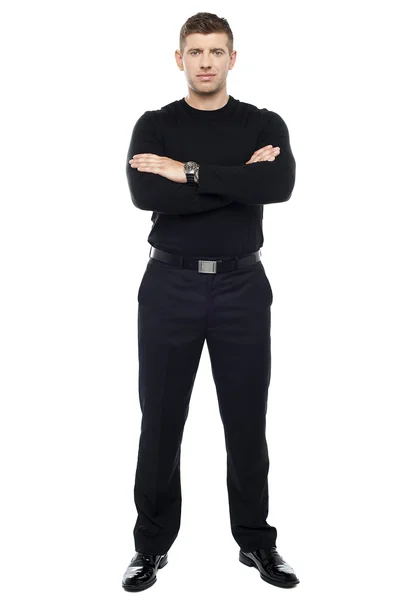 Young smart bouncer posing with his arms crossed . — Stock Photo, Image