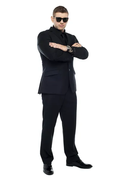 Young stylish bouncer in a black suit, arms folded — Stock Photo, Image