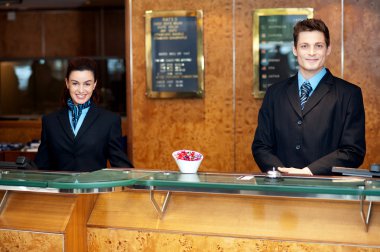 Front desk colleagues posing for a picture clipart