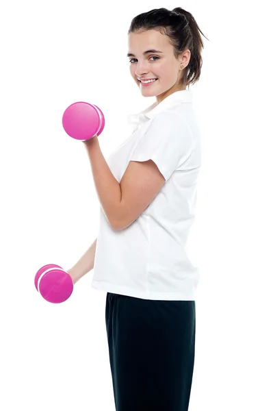 Side pose of girl with dumbbells working out — Stock Photo, Image