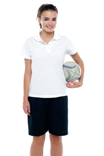 Sporty young girl holding a rugby ball — Stock Photo, Image