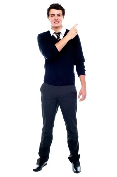 Full length portrait of teenager pointing away — Stock Photo, Image