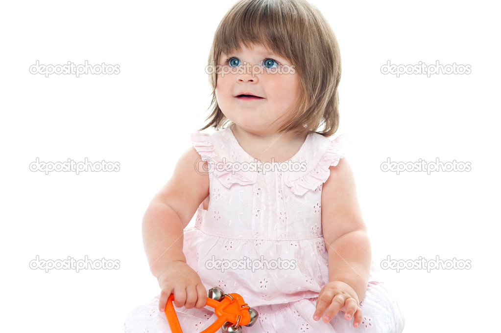 Adorable blonde infant playing with a rattle