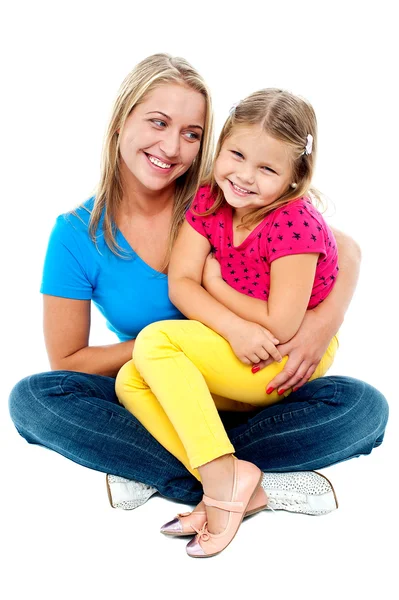 Cute daughter sitting in mother's lap — Stock Photo, Image