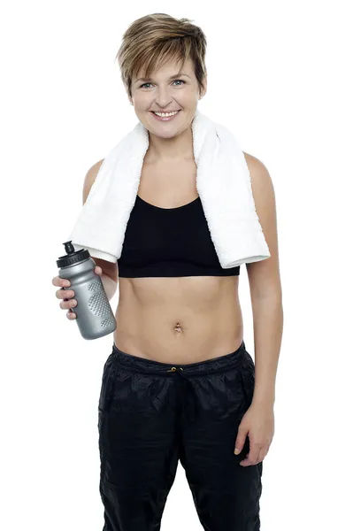 Charming fit lady holding up a bottle of water — Stock Photo, Image