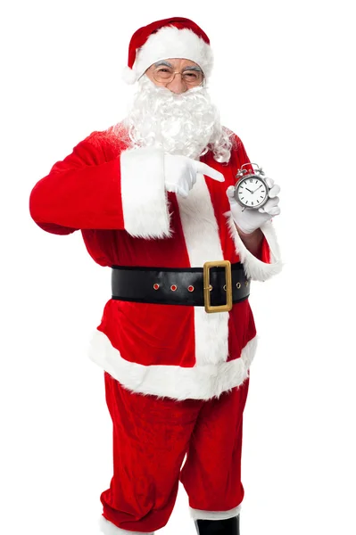 Santa pointing at an antique time piece — Stock Photo, Image