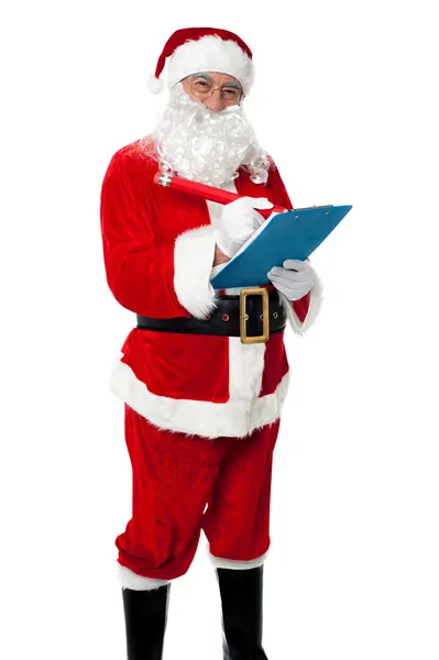 Santa claus maken van lijst met geadresseerden die u cadeau — Stockfoto