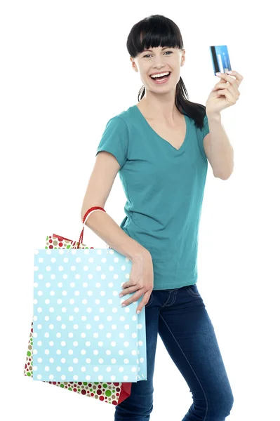 Shopaholic woman holding her cash card up — Stock Photo, Image