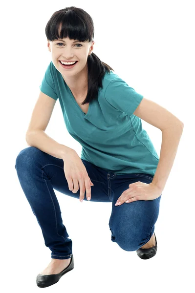 Good looking female model in squatting posture — Stock Photo, Image