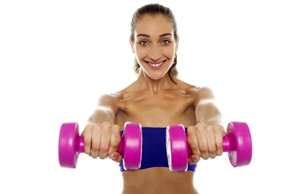 Lady lifting dumbbells, arms outstretched — Stock Photo, Image