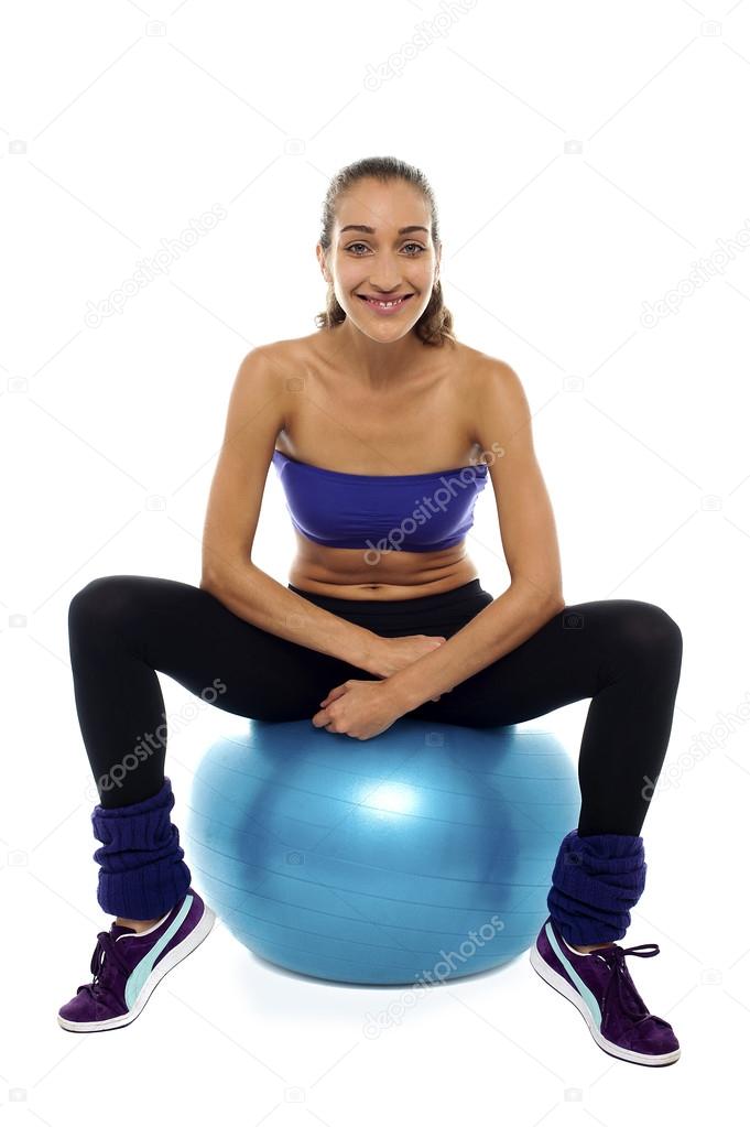 Fitness woman relaxing on exercise ball