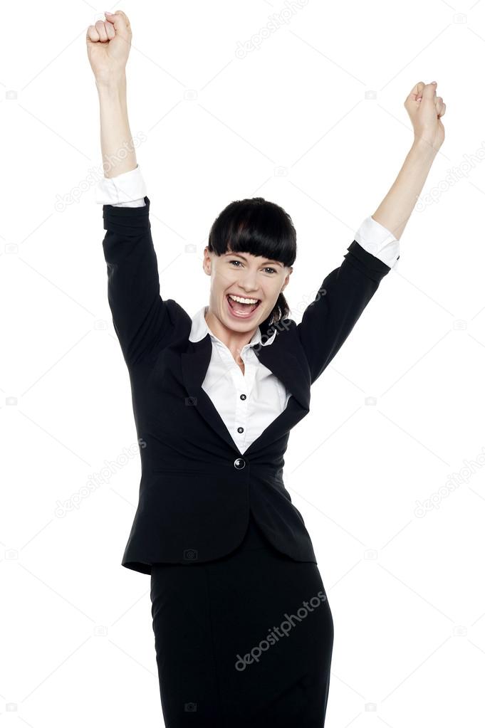 Jubilant corporate lady throwing up her hands