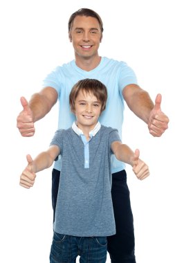 Handsome father and son showing thumbs up to camera clipart