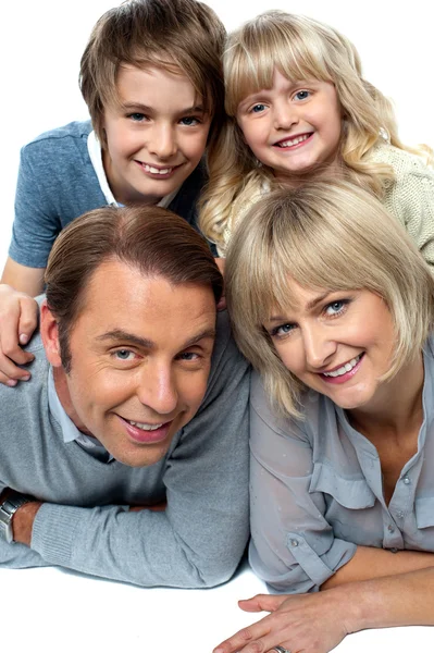 Parents lying down with children on top — Stock Photo, Image