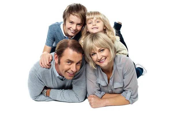 Adorable young kids piled on top of their parents — Stock Photo, Image