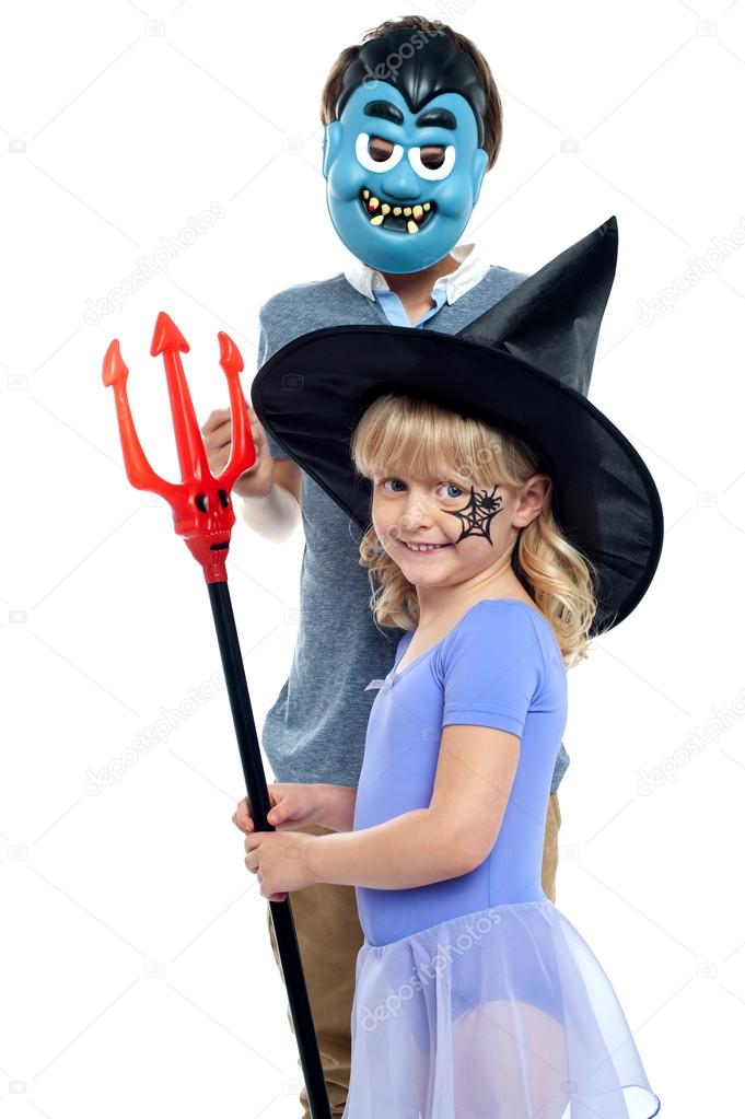 Young brother and sister in halloween costume