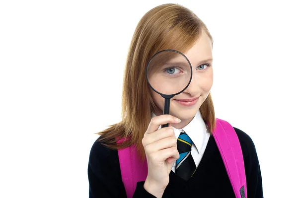 Teenager looking through a magnifying glass — Stock Photo, Image