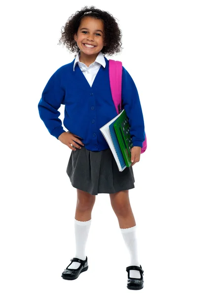 Menina em uniforme inteligente segurando notebook e calculadora — Fotografia de Stock