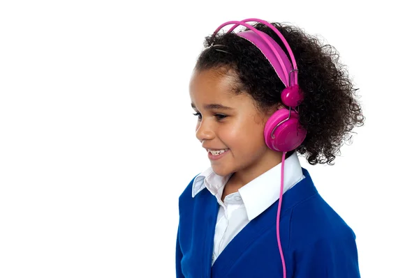 Charming young kid listening to music — Stock Photo, Image