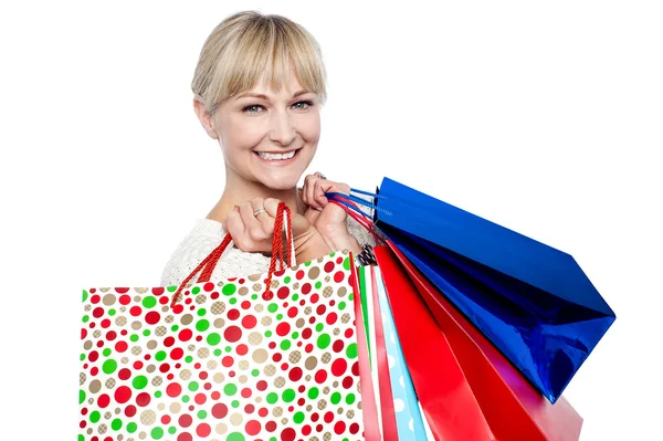 Pretty female carrying shopping bags over shoulders — Stock Photo, Image