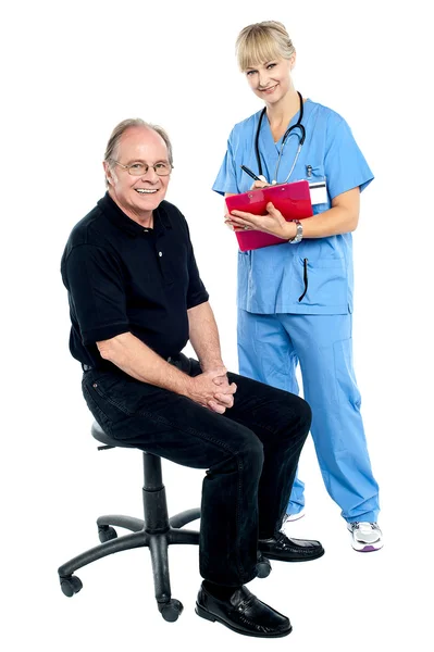 Pleasing doctor collecting patient's health history — Stock Photo, Image