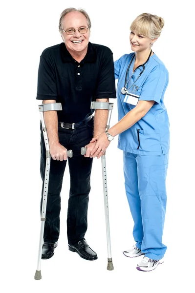 Experienced physician assisting her patient in recovery process — Stock Photo, Image