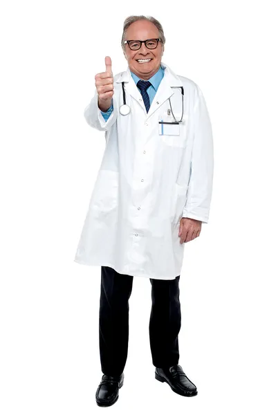 Successful senior doctor showing thumbs up sign to the camera Stock Photo