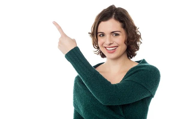 Charming woman pointing towards copy space area — Stock Photo, Image