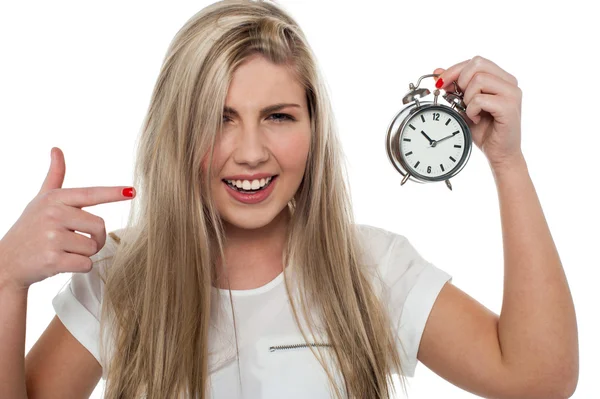 Girl pointing towards old fashioned time piece — Stock Photo, Image