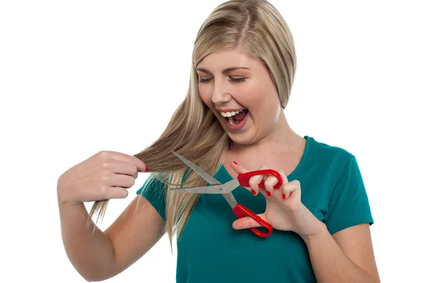 Excited blonde girl about to trim her hair in fun — Stock Photo, Image