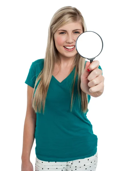 Attractive girl holding magnifying glass — Stock Photo, Image